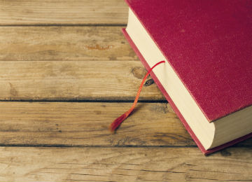 red_book_on_wood_table_0