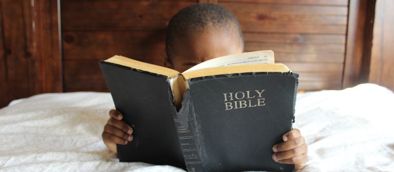 child_reading_bible_970_425